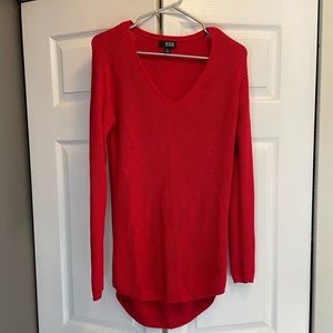 Red a.n.a sweater. Longer in the back. Need to wear a shirt underneath.